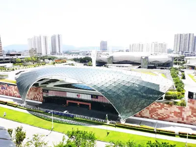 a large building with a curved roof in a city at TuR11-Oppesite Pisa Stadium-1min-FoodCourt-MiniMarket in Bayan Lepas