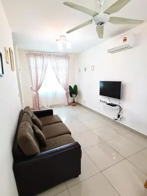 a living room with a couch and a flat screen tv at TuR11-Oppesite Pisa Stadium-1min-FoodCourt-MiniMarket in Bayan Lepas