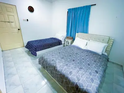 a bedroom with a bed and a window and a door at Tupai Mas Semi-D 4BR 2mins to LakeGarden & Zoo in Taiping