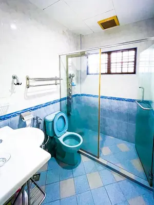 a bathroom with a blue toilet and a shower at Tupai Mas Semi-D 4BR 2mins to LakeGarden & Zoo in Taiping