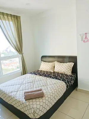 a bed in a bedroom with a large window at Mansion One Two Bedroom Seaview 7 Pax in George Town