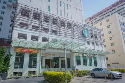 a building with a car parked in front of it at Mansion One Two Bedroom Seaview 7 Pax in George Town