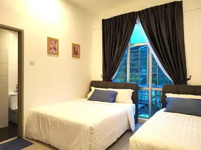 a bedroom with two beds and a large window at W39C WarmStay atGoldenHill NightMarket 2R WiFi CarPark in Brinchang