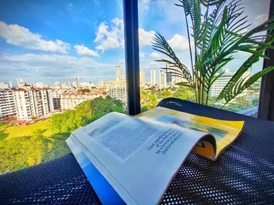 an open book sitting on a table in front of a window at Beacon Executive Suite at Georgetown for 10pax and 2 BED ROOM in George Town