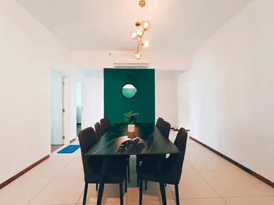 a dining room with a black table and chairs at The Landmark by Katana 3BR to 4BR Luxury Seaview Landmark Homestay at Gurney 15-16pax \u65e0\u654c\u6d77\u666f\u5957\u623f in Tanjong Tokong