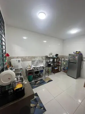 a room with a kitchen with a refrigerator in it at Hadeerna Homestay - Double storey terrace in Chemor