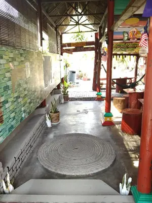 a patio with a large circle in the middle of a building at Nazri Nipah Camp Pangkor in Kampung Teluk Nipah