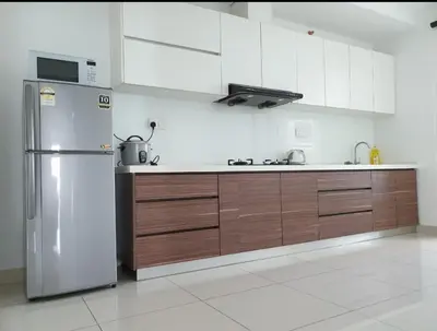 a kitchen with a stainless steel refrigerator and wooden cabinets at Mansion One 3 Bedroom SEAVIEW Gurney Georgetown 1-13Pax in George Town
