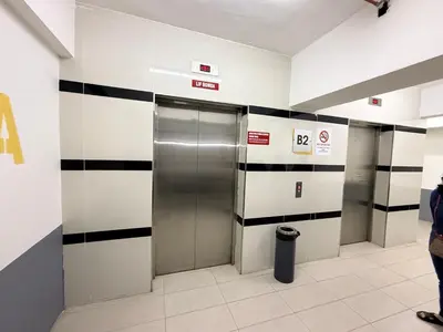 a hallway with a metal elevator in a building at Nova Sunrise n Mountain view Hilltop Hotel apartment in Nova Cameron Highlands in Brinchang