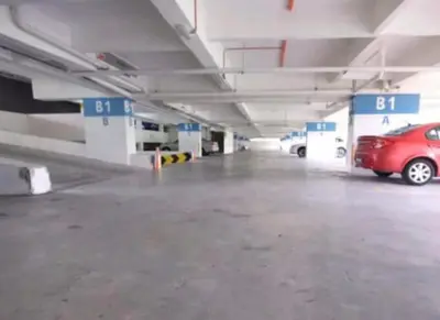 a parking garage with a red car parked in it at Nova Sunrise n Mountain view Hilltop Hotel apartment in Nova Cameron Highlands in Brinchang