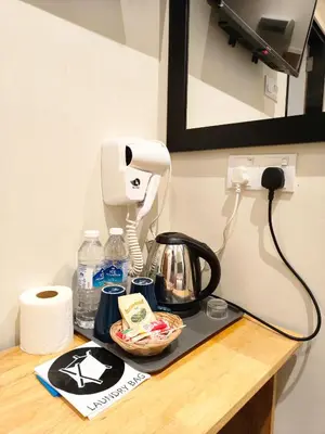 a counter with a coffee maker and a phone on it at Pangkor Pop Ash Hotel in Pangkor