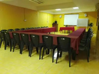 a conference room with a long table and chairs at KAMILA MOTEL TELUK SENANGIN in Lumut