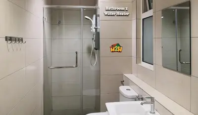 a bathroom with a shower and a toilet and a sink at H2H - Octagon Cottage at Ipoh Town Center in Ipoh