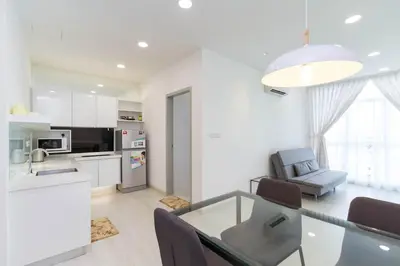 a kitchen and living room with a glass table and chairs at Deluxe & Feel Like a Home 2, 3-6pax, Netflix, Georgetown in Jelutong