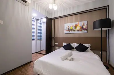 a bedroom with a large white bed in a room at Loft Pano Seaview Suite 2 Bedroom by The Only Bnb in Jelutong