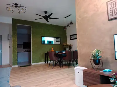 a living room with a table and a ceiling fan at Muslim Apartment at Meru in Ipoh