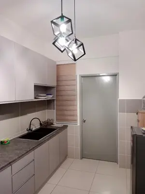 a kitchen with white cabinets and a sink and a light fixture at Muslim Apartment at Meru in Ipoh
