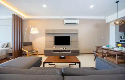 a living room with a couch and a tv at The Landmark Penang in Tanjong Tokong