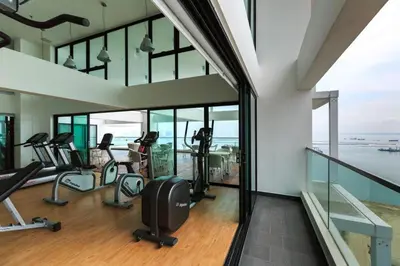 a gym with treadmills and ellipticals in a building at Sunrise Gurney Premium Executive City/Seafront suite - Penang in George Town