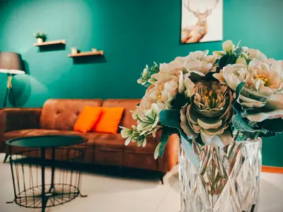 a vase of flowers in a living room with a couch at THE LANDMARK BY KATANA New 3BR Grand Seaview Homestay at Gurney \u65e0\u654c\u6d77\u666f\u4e09\u623f\u5957\u623f in Tanjung Bungah