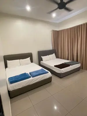 two beds sitting next to each other in a room at 18PAX 4BR Villa with Kids Swimming Pool, KTV, BBQ near SPICE Arena Penang in Bayan Lepas