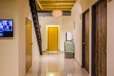 a hallway with a yellow door and a yellow elevator at Explore 5BR Gardenhouse Retreats (Free Parking) in Butterworth