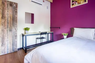 a bedroom with a white bed and a desk at Explore 4BR Gardenhouse Retreats (Free Parking) in Butterworth