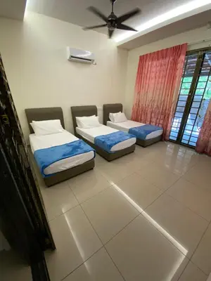 a room with two beds and a ceiling fan at 40 PAX 9BR Villa with Kids swimming Pool, KTV, BBQ n Pool Tables near SPICE Arena Penang 9800 SQFT in Bayan Lepas