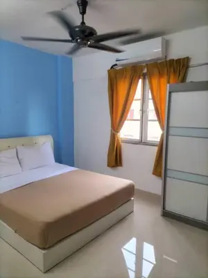 a bedroom with a bed and a ceiling fan at Homestay pangsapuri sutera seberang jaya in Kampong Telok
