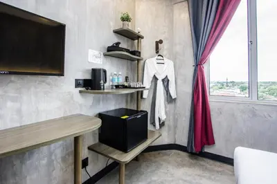 a room with a bar with a table and a window at Sri Indar Hotel & Suites in Parit Buntar