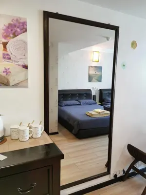 a bedroom with a bed and a large mirror at C 13 Lot 10 Pangkor Leisure Beach Studio in Pangkor