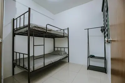 a bedroom with two bunk beds and a mirror at Ipoh Manhattan Premium Suites by Verve in Ipoh