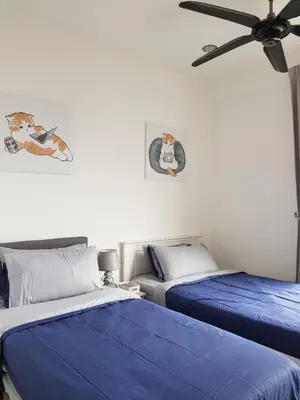 a bedroom with two beds and a ceiling fan at Mansion One Suite by stayCATion Homestay in George Town