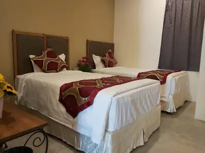 two beds in a hotel room with at KB HOTEL in Kepala Batas