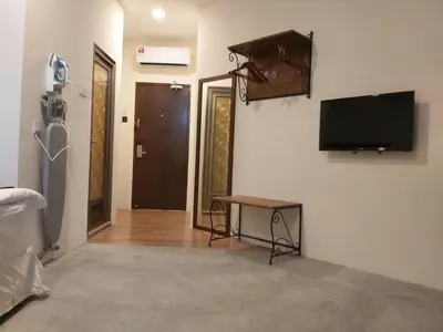 a living room with a flat screen tv on a wall at KB HOTEL in Kepala Batas