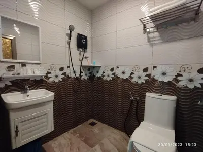 a bathroom with a white toilet and a sink at KB HOTEL in Kepala Batas