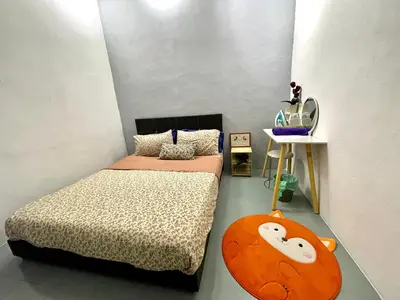 a bedroom with two twin beds and a table at Heritage Cozy Entire 3 Bedroom House At Kijang Alma Bukit Mertajam in Bukit Mertajam