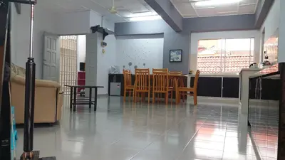 a dining room with a table and chairs at Coastside Homestay in George Town