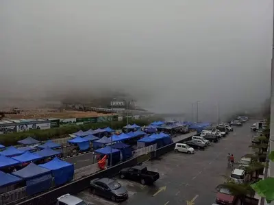 a parking lot with blue tents and cars parked at D&C Homestay A Modern Forest Boutique in Brinchang