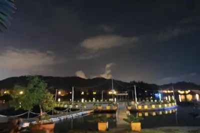 a marina at night with aocked boats in the water at Rustic one bedroom unit for 4pax by Jomy Management in Lumut