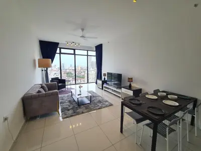 a living room with a table and a couch at Beacon Executive Premium Suite in George Town