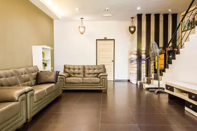 a waiting room with couches and chairs in a store at Value Inn Homestay in Butterworth