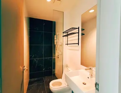 a bathroom with a toilet and a sink and a shower at Bali-style 2Bedroom Beacon Georgetown WL in George Town
