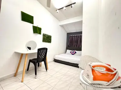 a room with a bed and a table and a chair at Cozy Murni 14th Entire 3 Bedroom House at Alma Bkt Mertajam in Bukit Mertajam