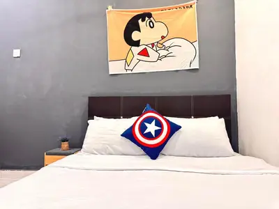 a bed with a superman pillow on top of it at Cozy Murni 14th Entire 3 Bedroom House at Alma Bkt Mertajam in Bukit Mertajam
