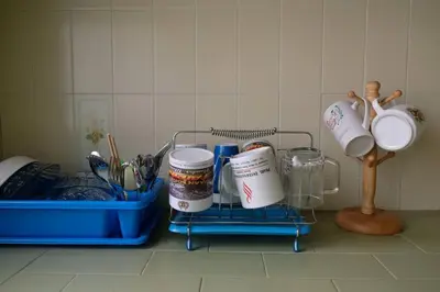 a kitchen counter with a rack with cups and utensils at Simple Home Taiping \u7b80\u5c45 Lakeview in Taiping