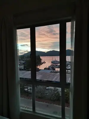 a view of a marina from a window at Spacious & Homey Apartment at Marina Island by JoMy Homestay in Lumut