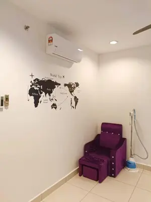 a room with a purple chair and a world map on the wall at Mansion One Seaview Luxury 2 Bedroom Gurney Georgetown gleneagles in George Town