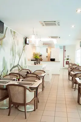 a dining room with wooden tables and chairs at Victoria Inn, Penang in George Town