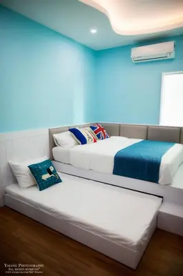 two beds in a room with blue walls at Pearl Rice Garden (European Style) in Sekincan
